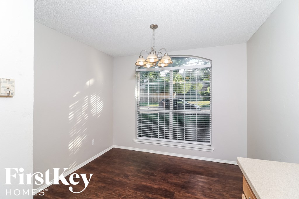 A room with a FirstKey Homes logo on the bottom left corner.