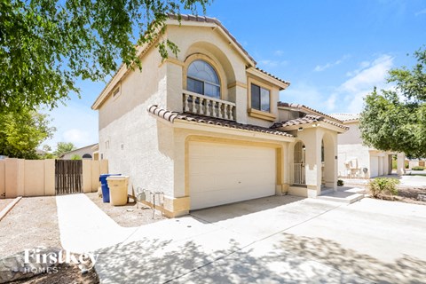 a white and yellow house with a white garage door