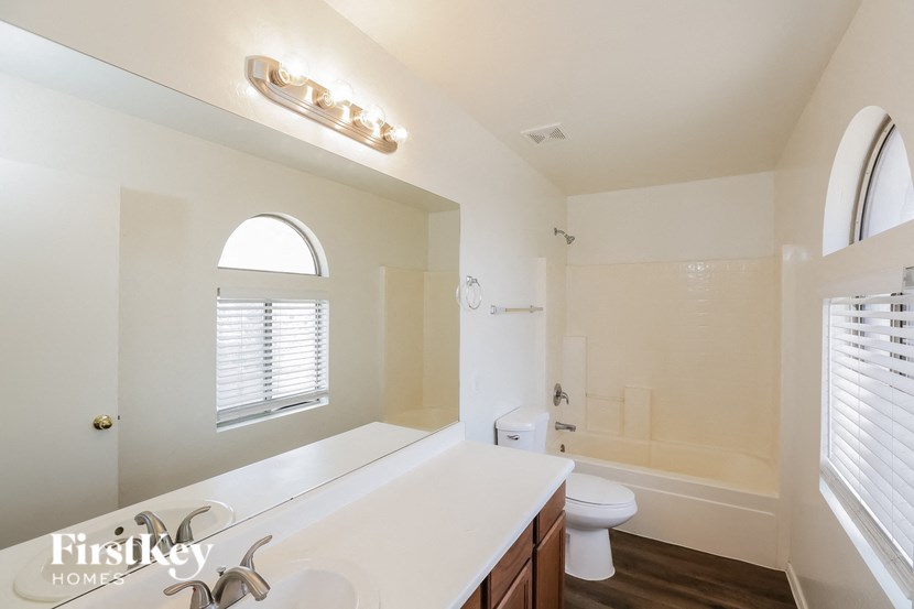 a bathroom with a sink and a toilet and a mirror