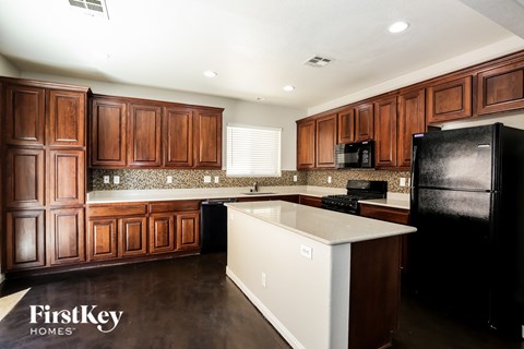 A kitchen with wooden cabinets and a white countertop.
