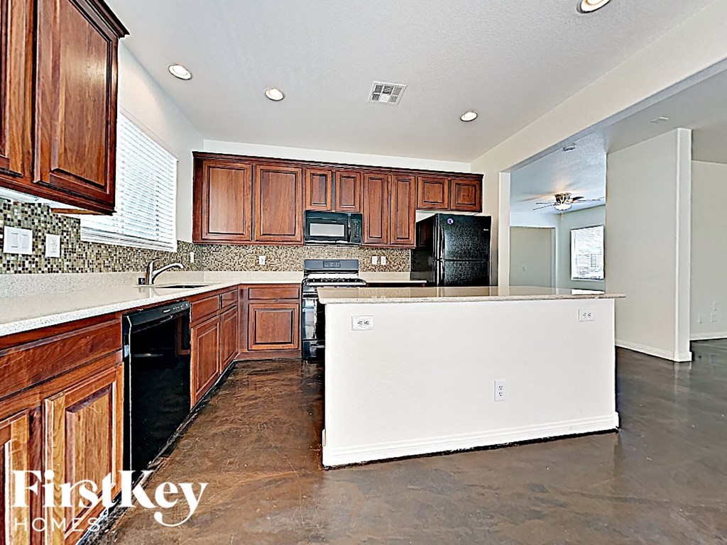 A kitchen with wooden cabinets and a white counter.