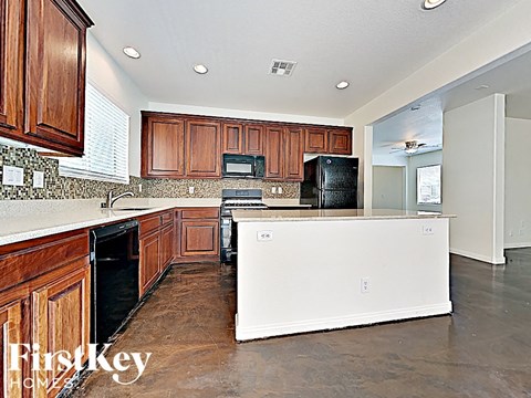 A kitchen with wooden cabinets and a white counter.