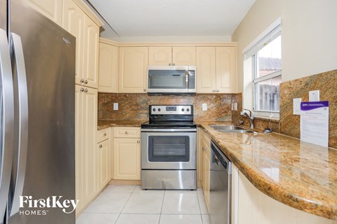 a kitchen with stainless steel appliances and a granite counter top