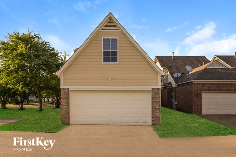 A house with a garage door and a window is shown.