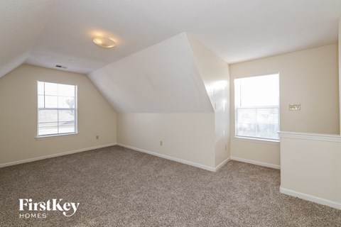 A sparsely furnished room with a FirstKey Homes logo.