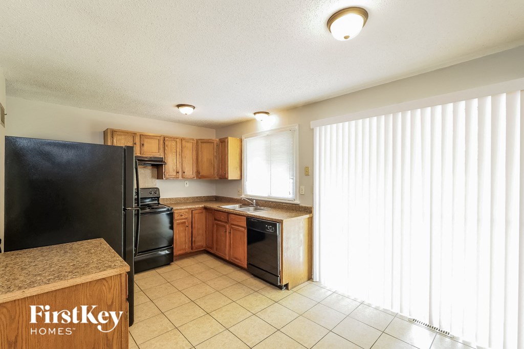 a kitchen with black appliances and wooden cabinets
