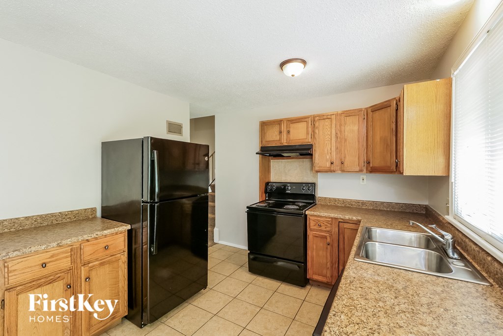 a kitchen with black appliances and wooden cabinets