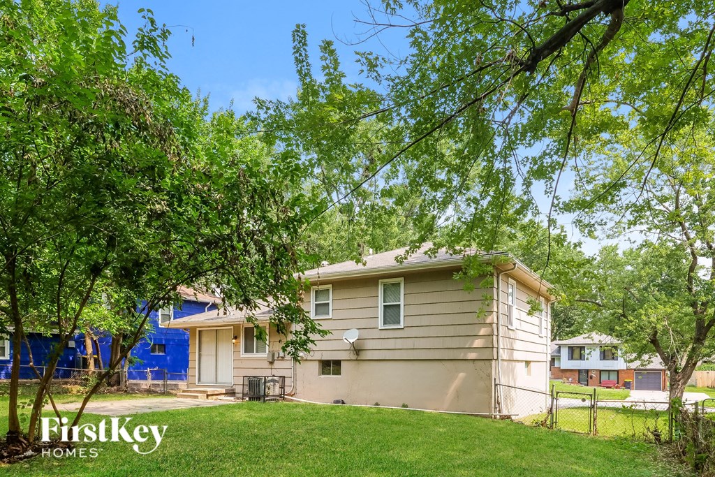 a small house with a yard and trees