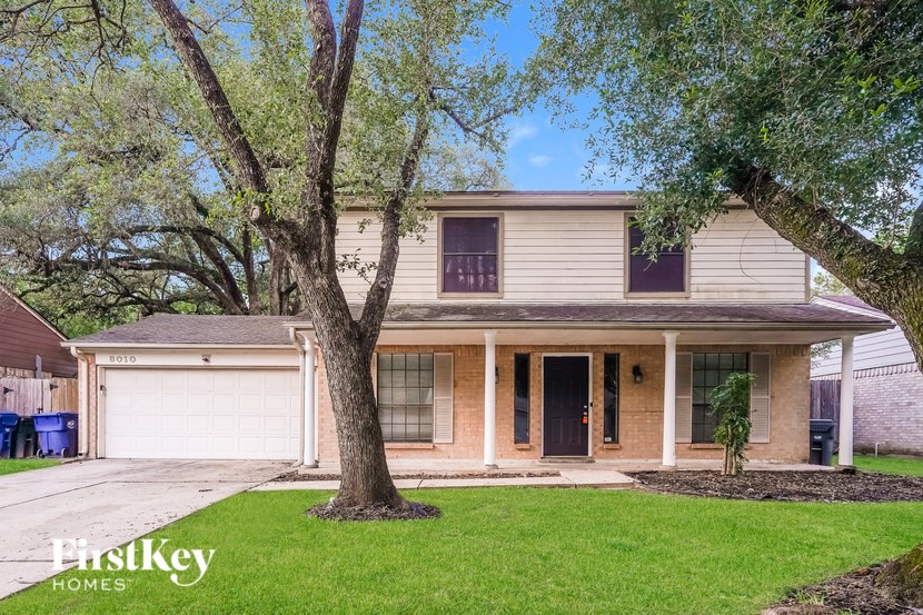 A house with a tree in front of it.