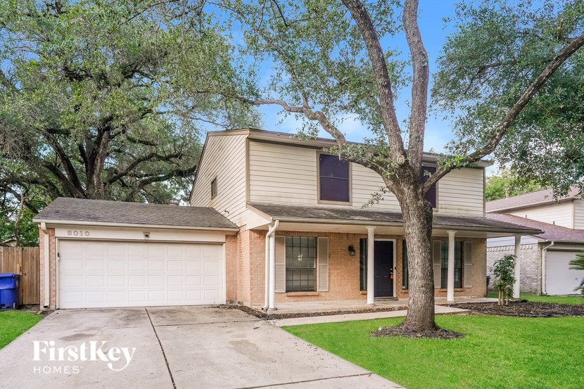 A house with a tree in front of it.