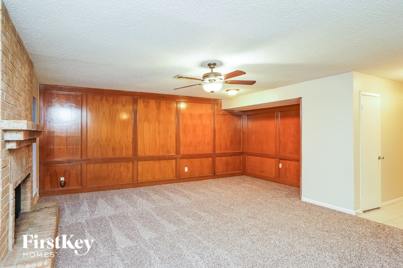 A room with wooden walls and a carpeted floor.