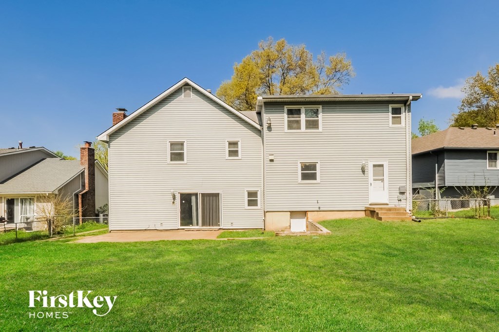 a white house with a yard in front of it