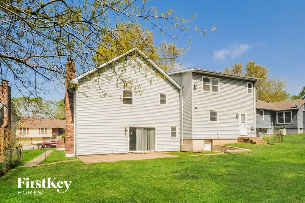 a white house with a garage and a green lawn