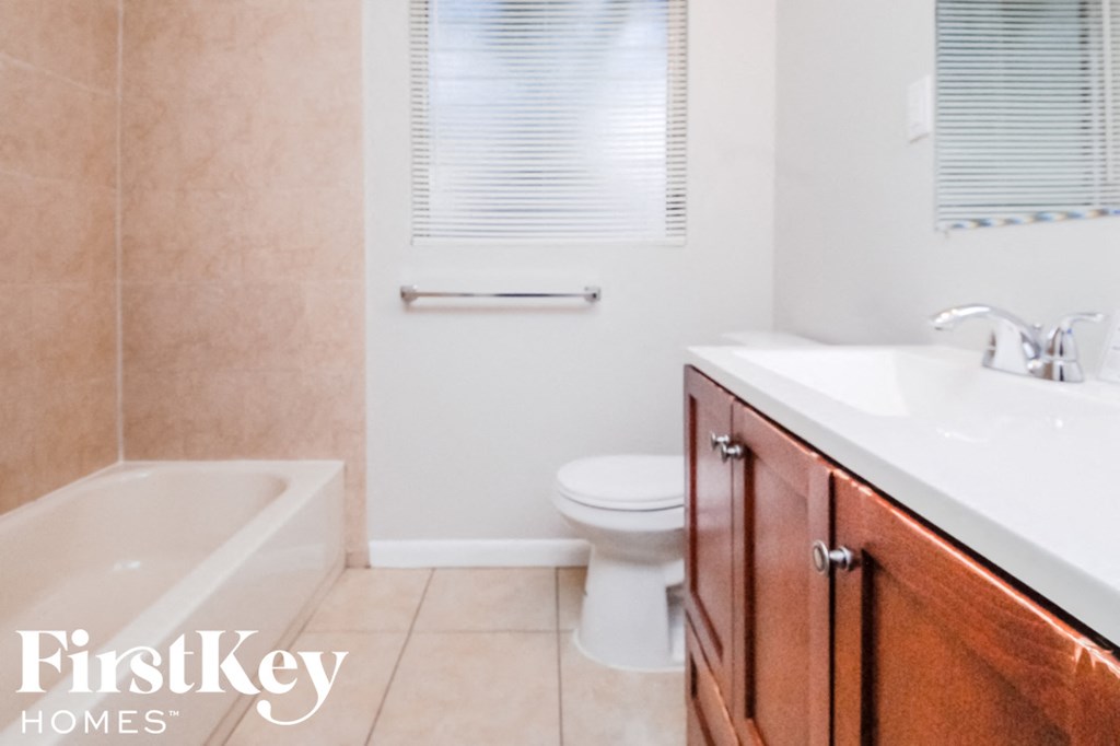 a bathroom with a sink toilet and a bath tub