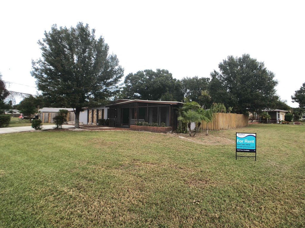 A sign in a field that says "First Rent".