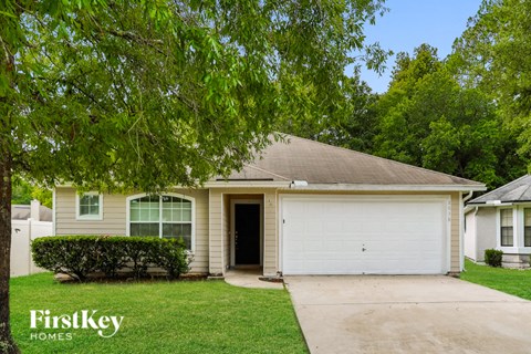 a white house with a white garage door