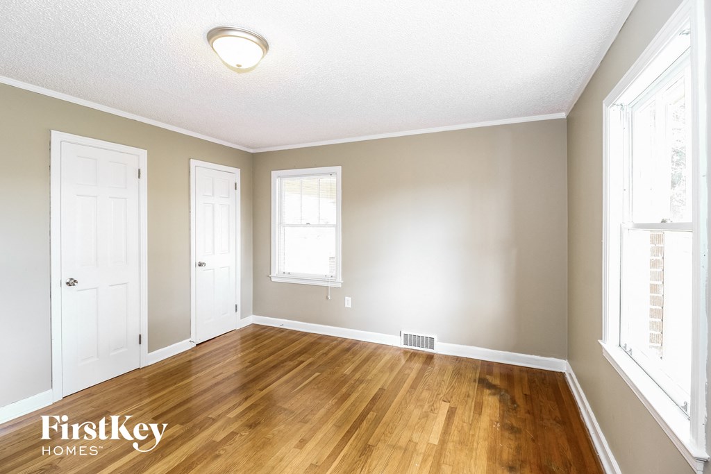 the living room of an empty house with a wood floor