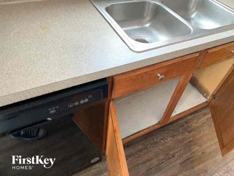 A kitchen with a sink and a dishwasher.