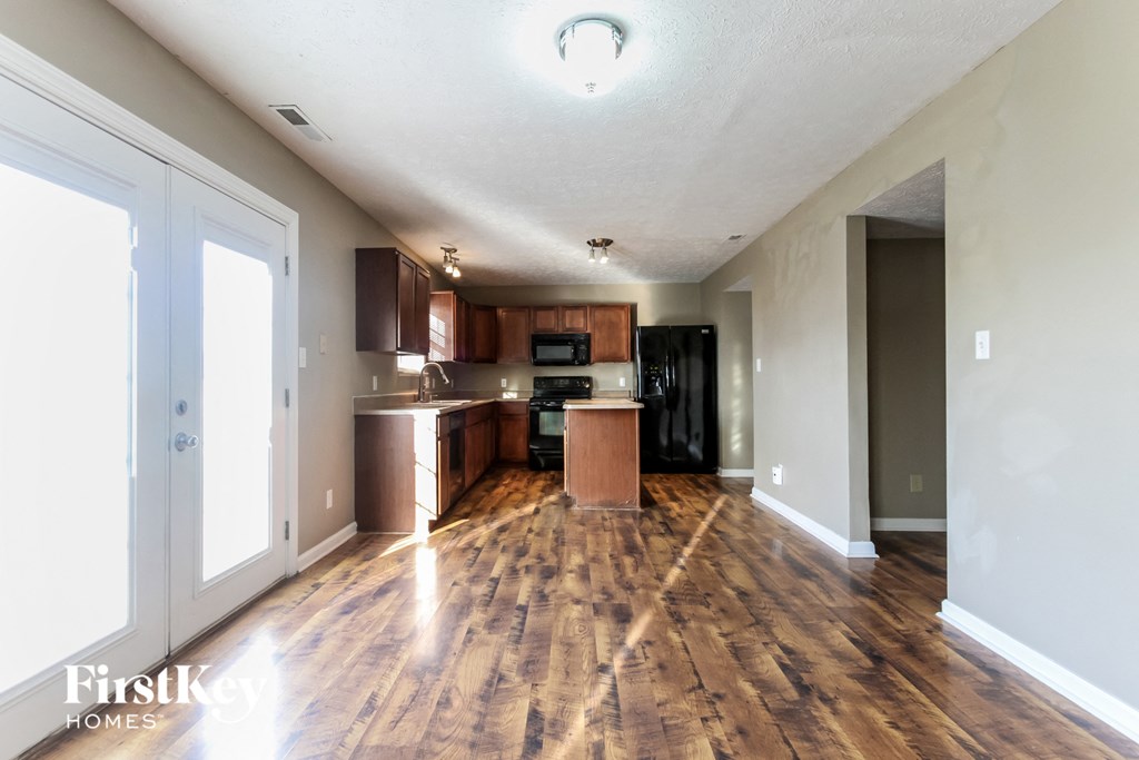 a kitchen and living room with wood flooring and