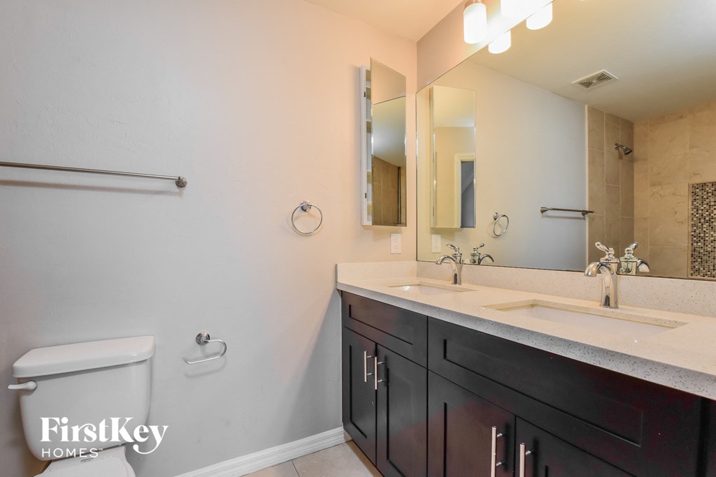 a bathroom with a sink and a toilet and a mirror