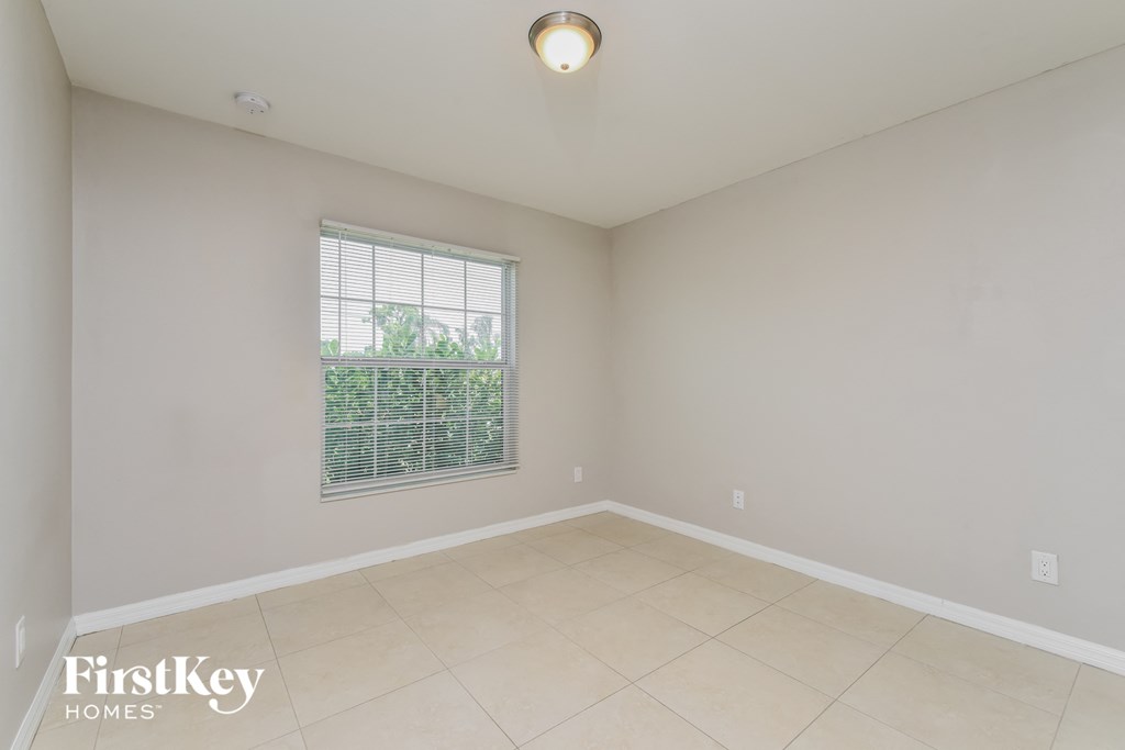 the living room of an empty house with a large window