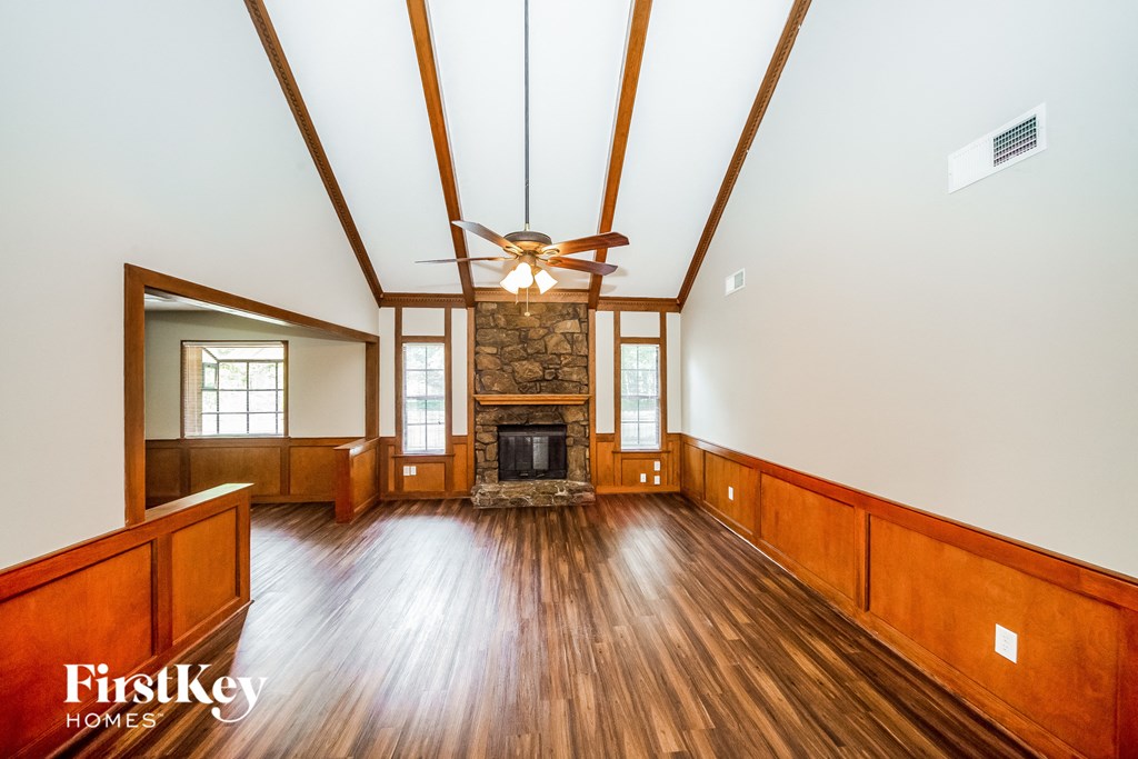 a living room with wood floors and a fireplace