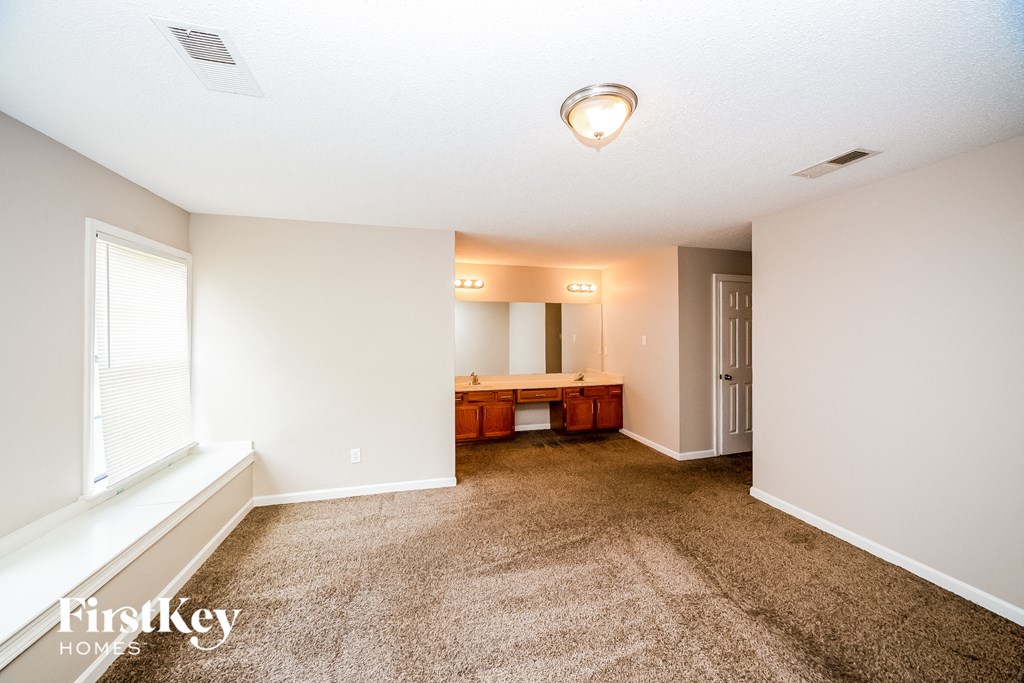 a living room with carpet and a large window