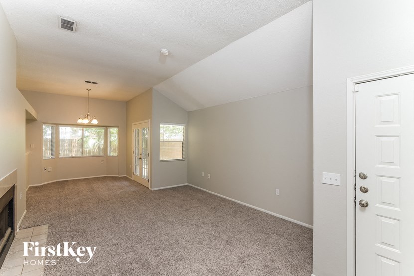 the living room and dining room of an empty house