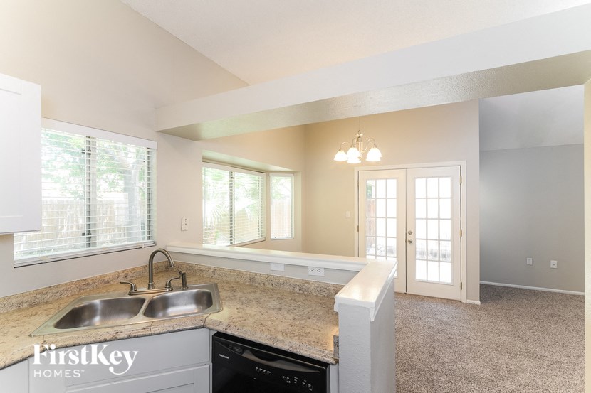 a kitchen with a sink and a window and a door