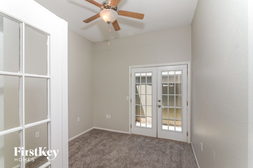 a bedroom with a ceiling fan and a window