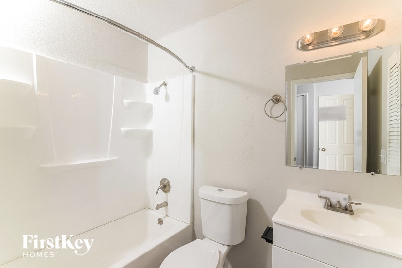 a bathroom with a sink toilet and a bath tub