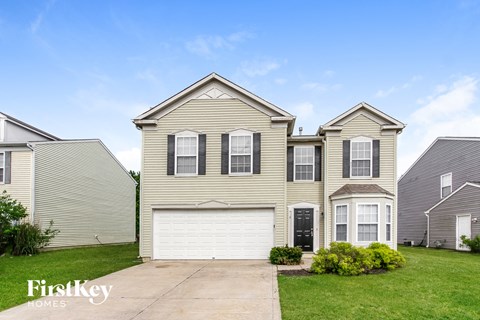 a tan house with a white garage door