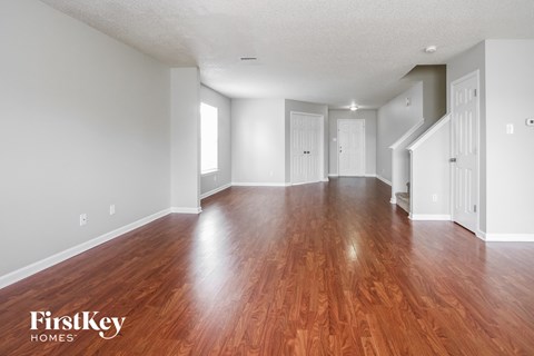 the living room and dining room with hardwood flooring