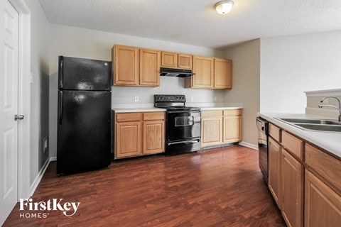 a kitchen with wooden cabinets and black appliances