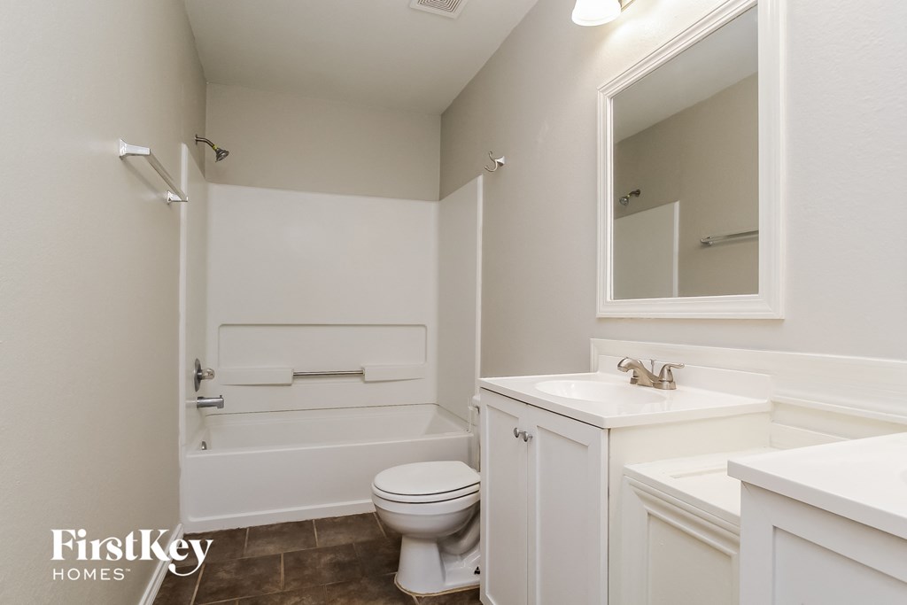 a bathroom with a toilet and a sink and a bath tub