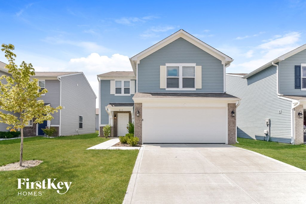 A house with a garage is shown in a real estate photo.
