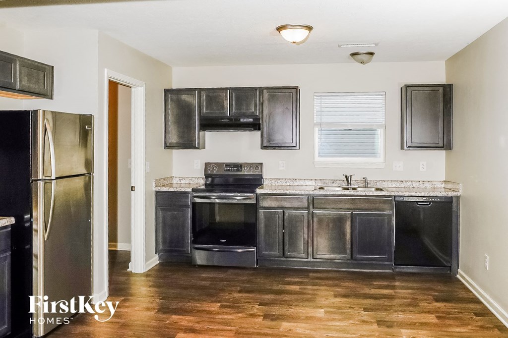 a kitchen with stainless steel appliances and black cabinets