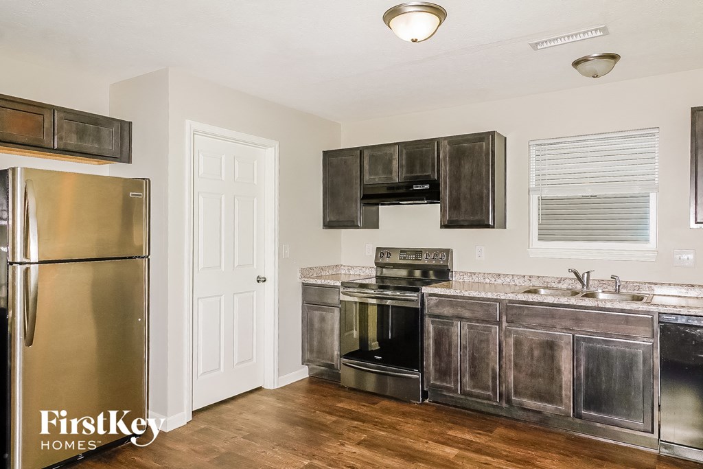 a kitchen with stainless steel appliances and wooden cabinets