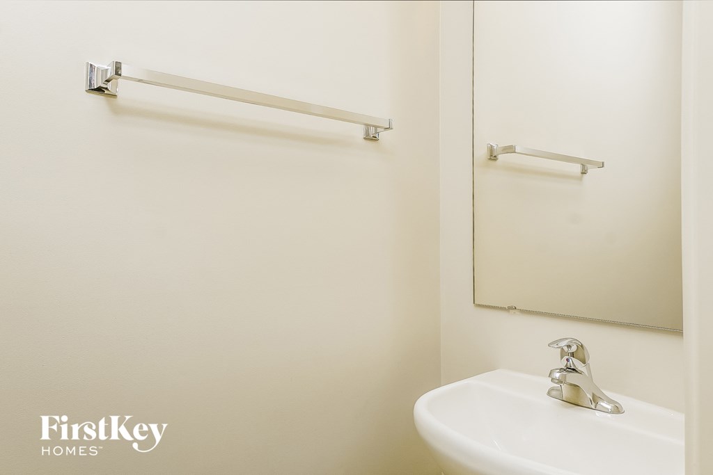 a small bathroom with a sink and a mirror