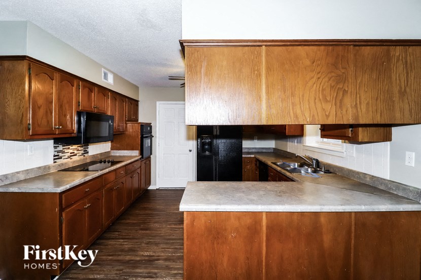 A kitchen with wooden cabinets and a countertop.