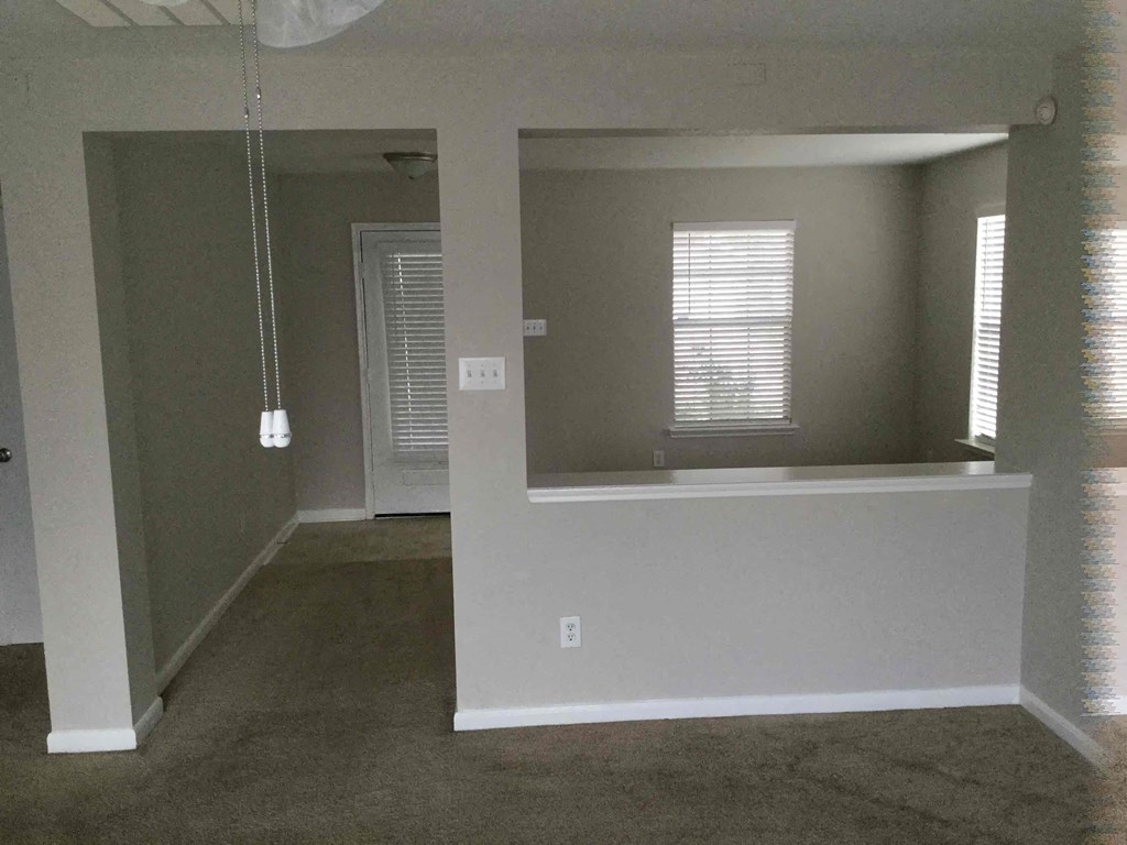 A room with a window and a door.