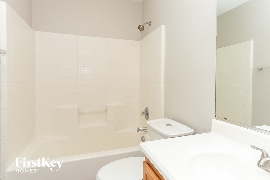 a white bathroom with a sink toilet and tub