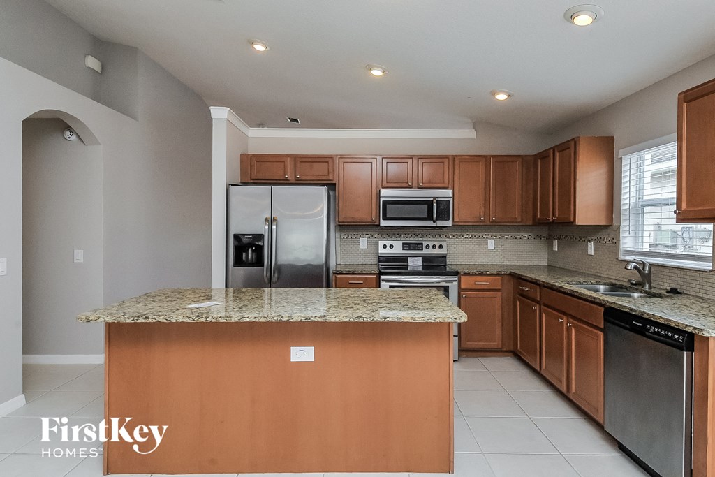 a kitchen with stainless steel appliances and granite counter tops