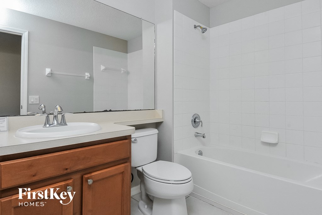 a bathroom with a sink toilet and a tub