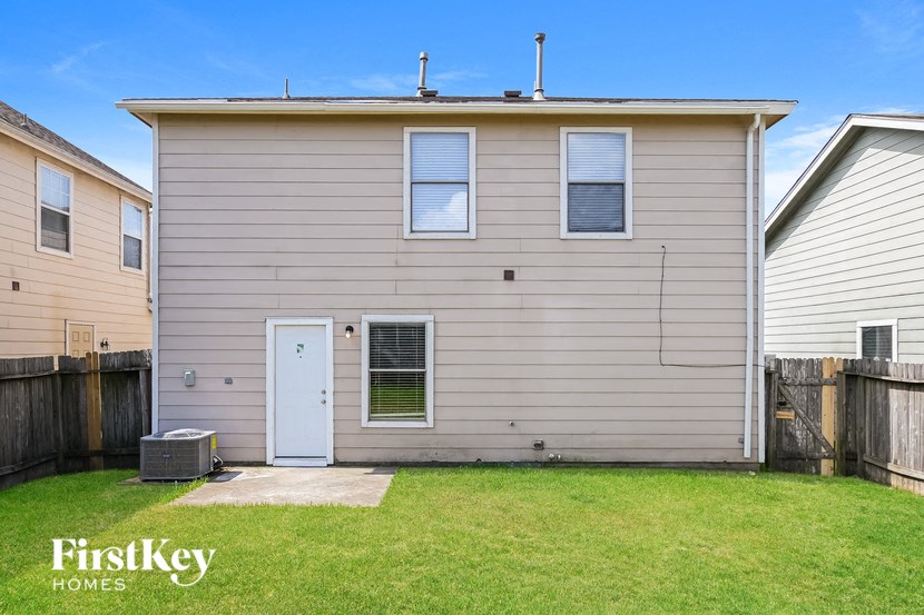 the exterior of a home with a blue door and a lawn