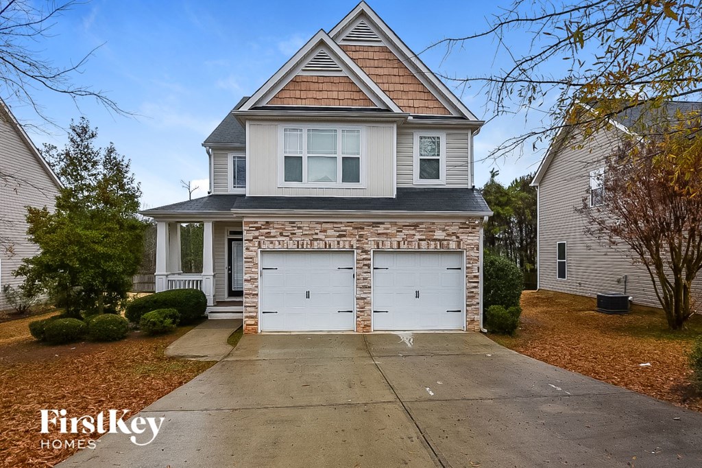A two-story house with a garage is for sale.