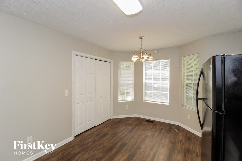 a living room with a refrigerator and a door