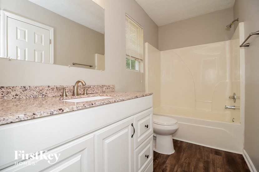 a white bathroom with a sink and a toilet