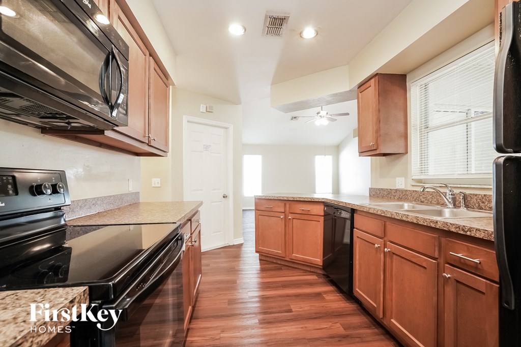 a kitchen with wooden cabinets and stainless steel appliances