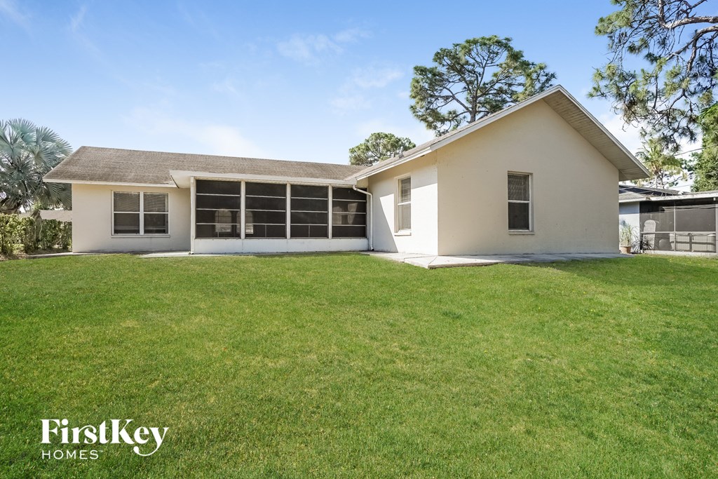 a white house with a grassy yard and a lawn